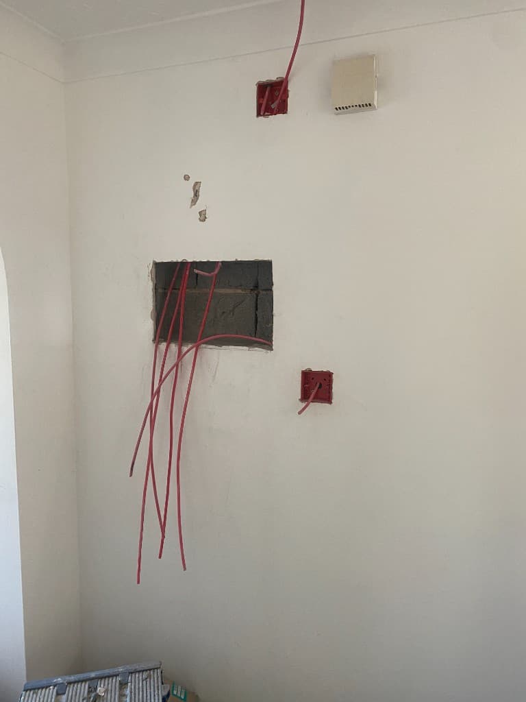 Fire-alarm first-fix wiring and back boxes before the control panel is fitted