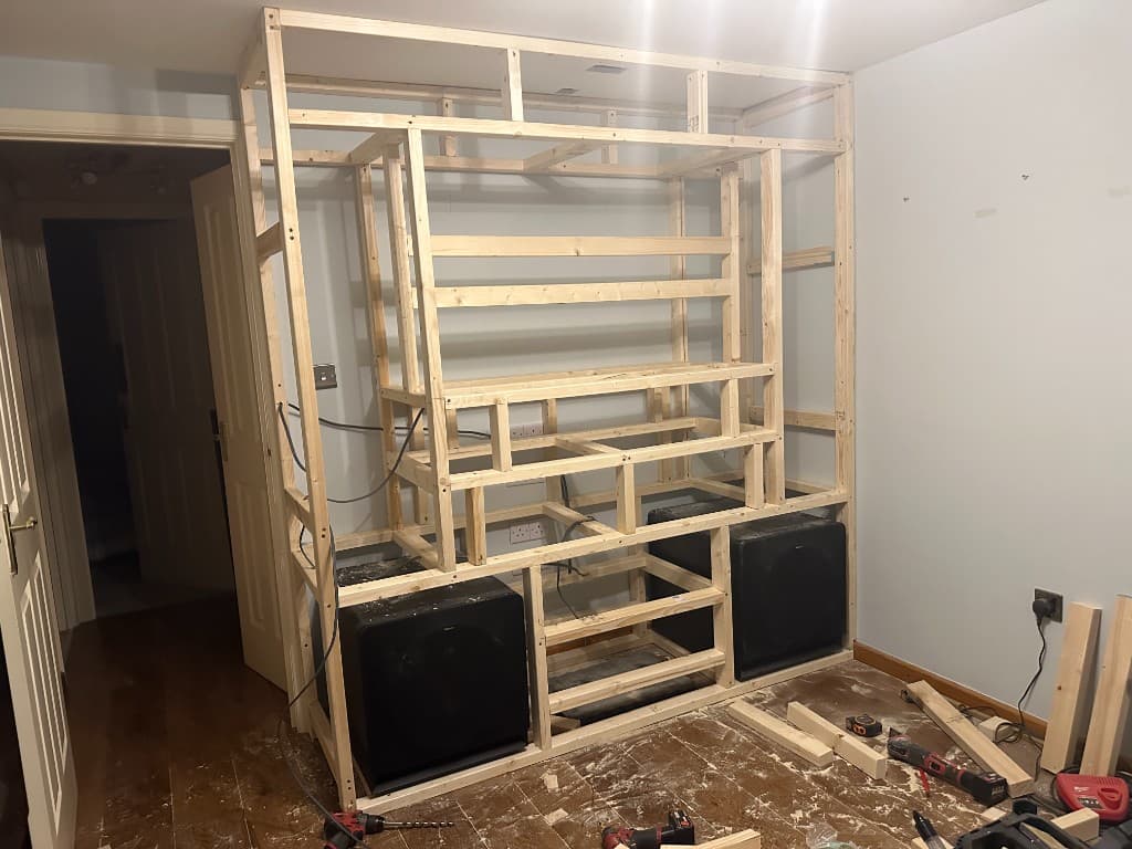 Timber frame for a media wall, with speaker positions set before boarding